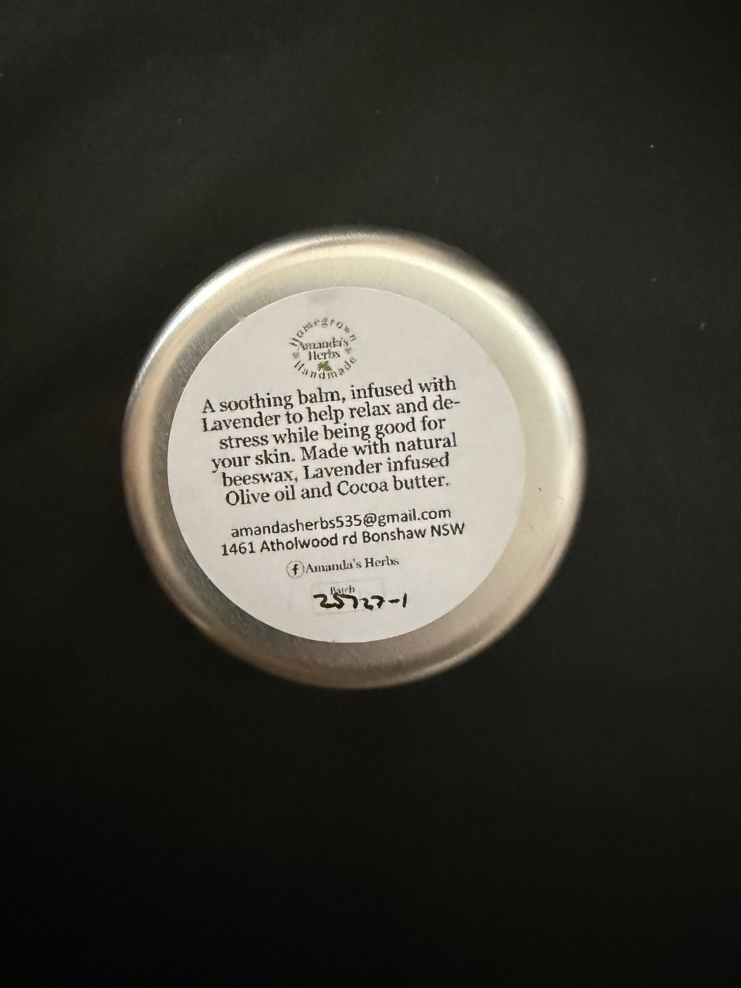 Metallic container lid with text on a black background