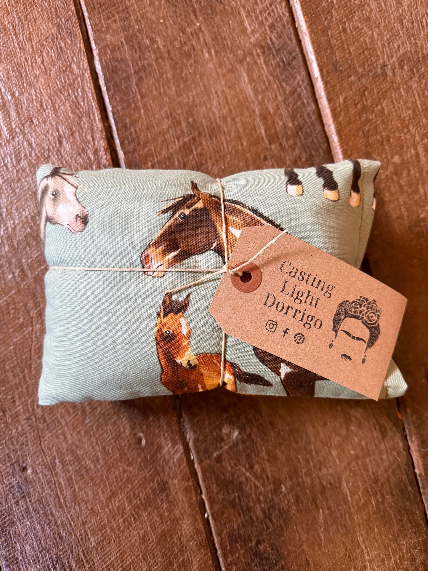 Small package with horse design and tag on a wooden surface