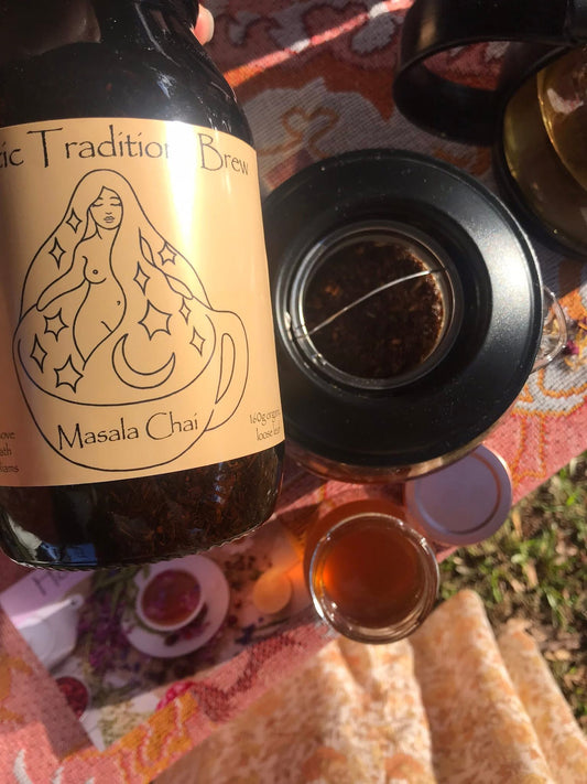 Bottle of Masala Chai with a label featuring a mermaid design on a colorful tablecloth.